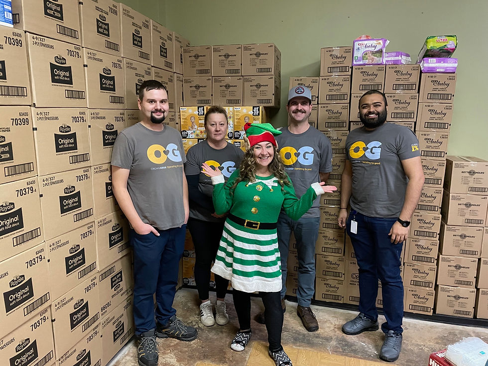 A group photograph of 5 Organigram employees taing part in a holiday-themed charity event, one of the employees is dressed as an elf
