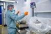 An image of a worker at our Moncto site weighing a large, clear bag full of cannabis for international shipments
